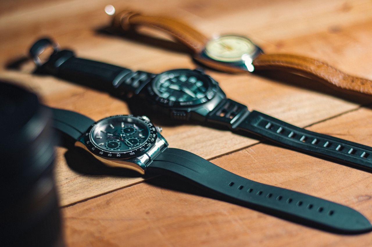 who-we-are Close-up of elegant analog wristwatches on a wooden surface, showcasing style and craftsmanship.
